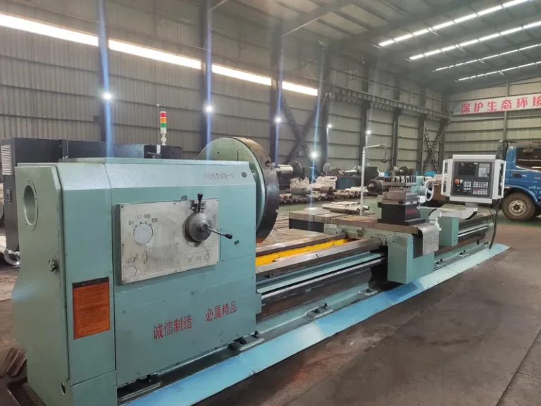 A heavy-duty CNC roll turning lathe equipped with a digital control panel, used for machining DURON mill rolls.