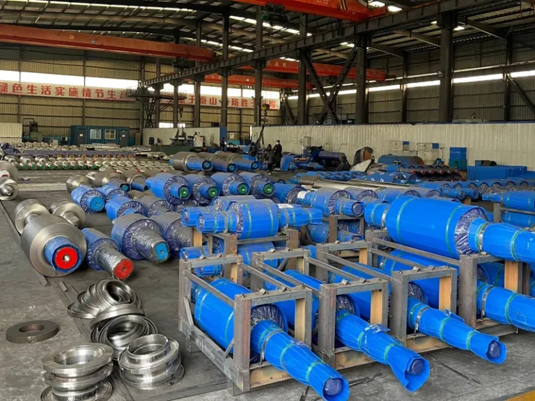 Comprehensive warehouse view displaying finished hot-rolled mill rolls, precision roll rings, and metallurgical components awaiting shipment.