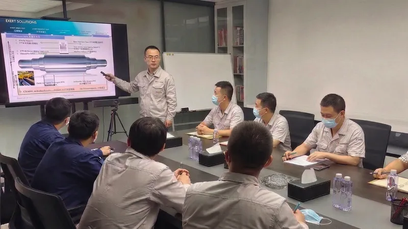 DURON technical and R&D team holding a meeting to discuss specific rolling mill conditions and design customized high-performance cast roll solutions.