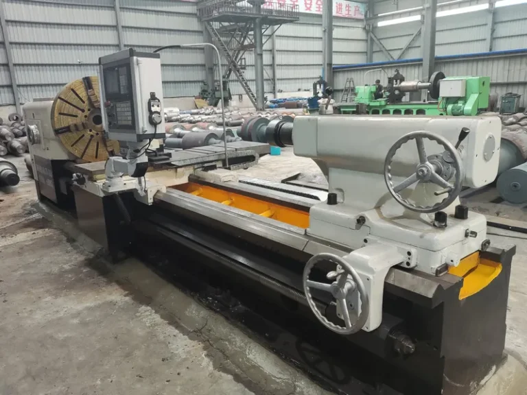 Heavy-duty CNC roll turning lathe processing large metallurgical mill rolls in the DURON manufacturing facility.