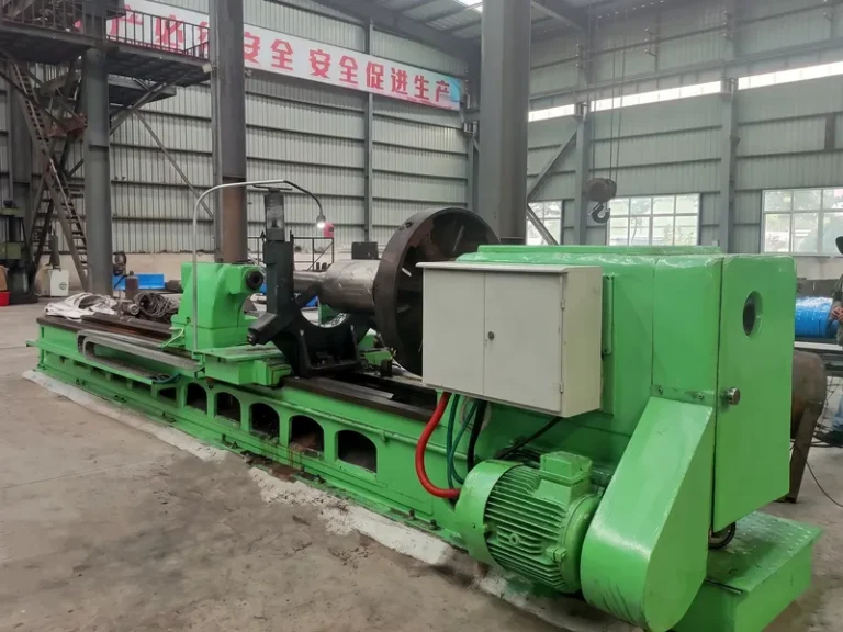 Heavy-duty roll turning lathe machining a metallurgical mill roll in the manufacturing facility.
