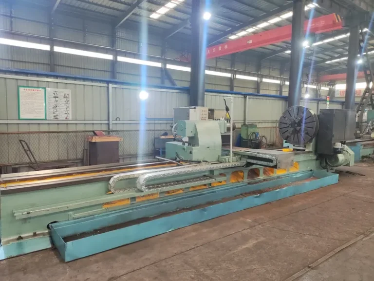 Heavy-duty roll turning lathe with an extended bed, used for machining long industrial mill rolls.